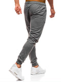 Man wearing the grey tapered jogger pants, side view
