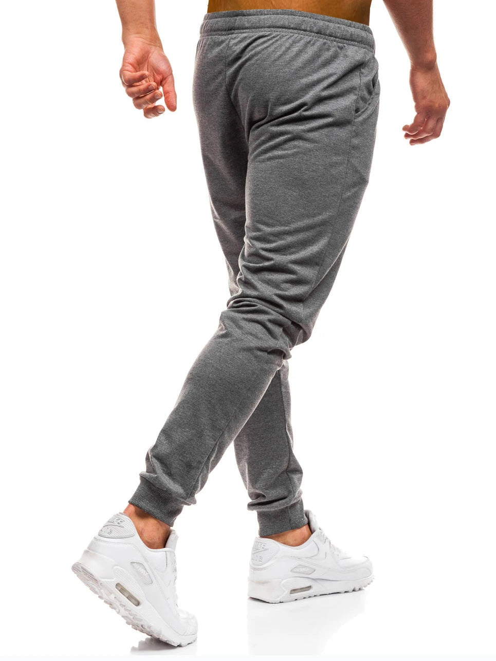 Man wearing the grey tapered jogger pants, side view