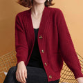 Woman wearing the burgundy cable-knit button-front cardigan