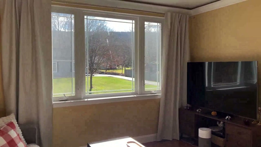 Natural linen texture 100% blackout curtains hanging as a pair in a living room