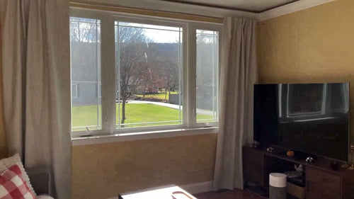 Natural linen texture 100% blackout curtains hanging as a pair in a living room